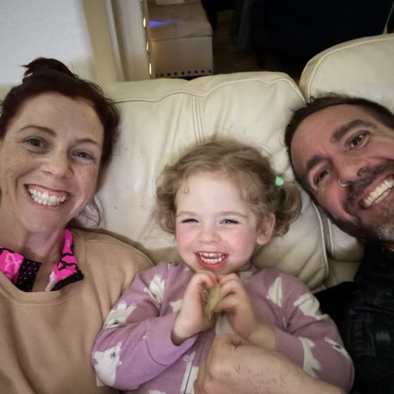 Mike, his wife, and daughter on the couch